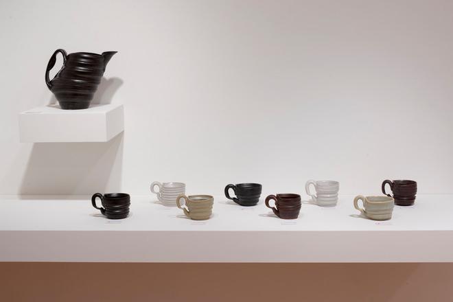 black vase and various colored mugs